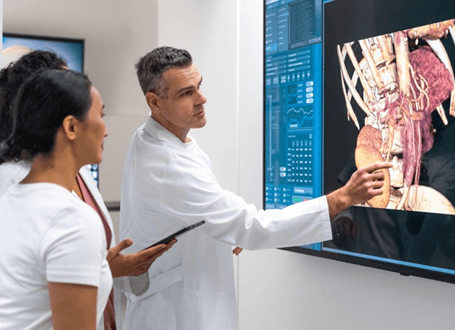 Medical professionals in a modern imaging facility reviewing diagnostic technology
